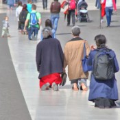 Pilgrims walking the long path of the courtyard on their knees in worship, or looking for a plenary indulgence